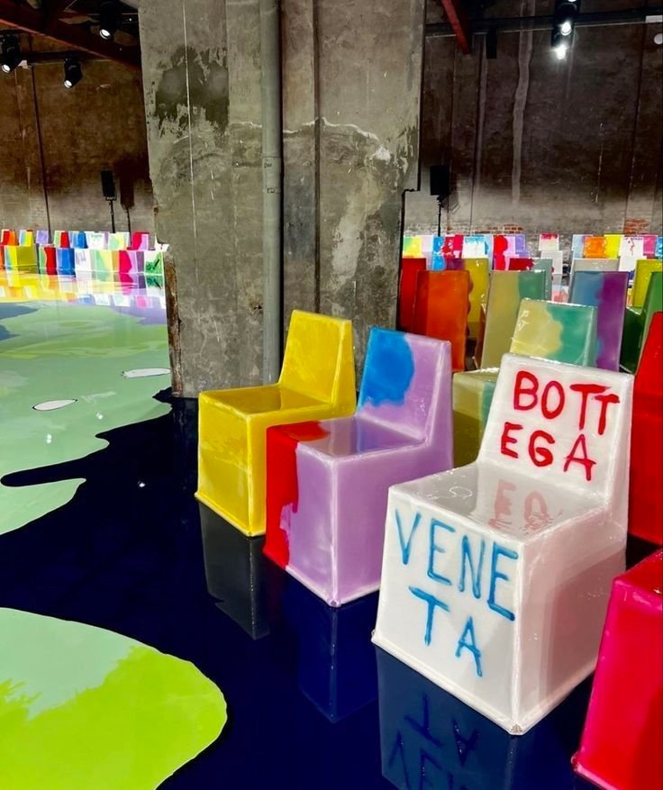 Chunky translucent chairs in bright colours, hand-lettered