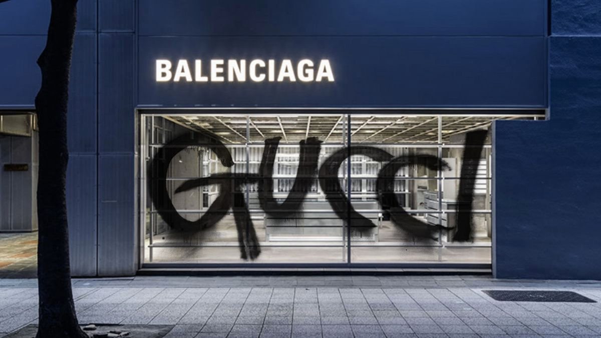 A shopfront window painted over with bold hand-drawn black lettering