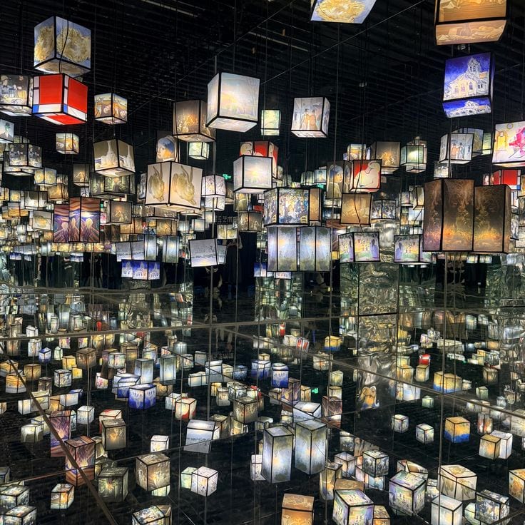 A room of suspended illuminated lanterns