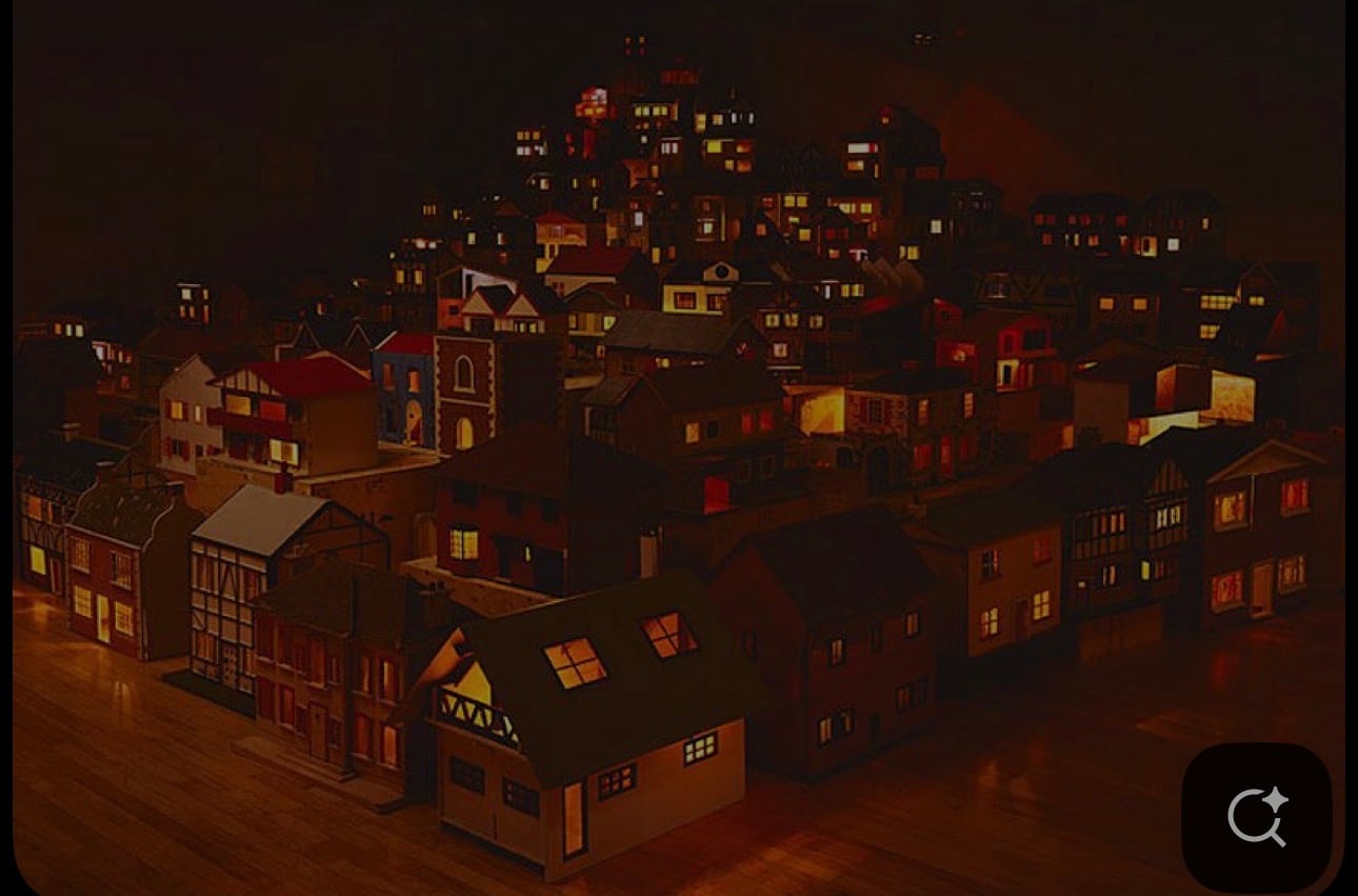 A miniature lit village seen from above